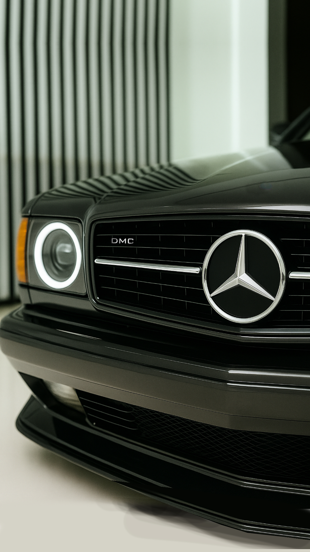 DMC Mercedes-Benz 560 SEC Widebody with modern LED lighting in a minimalist showroom